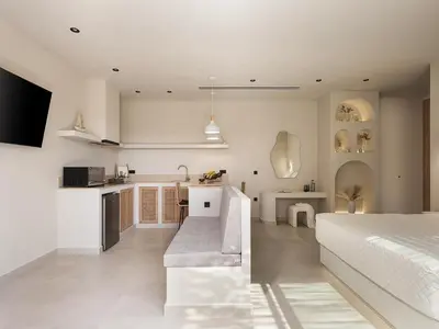 a kitchen and a bedroom with a bed and a kitchen and a living room at Vanilla Suites with Hot Tub in Daratso