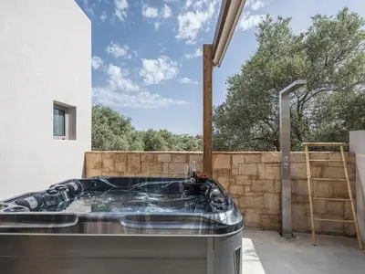 a hot tub in the backyard of a house at Vanilla Suites with Hot Tub in Daratso