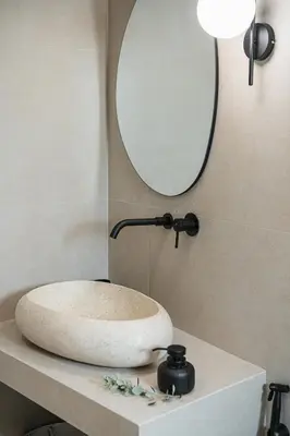a bathroom sink on a counter with a mirror at Vanilla Suites with Hot Tub in Daratso