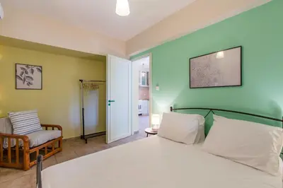a bedroom with a bed and a chair at Ellie Villa in Tersanas