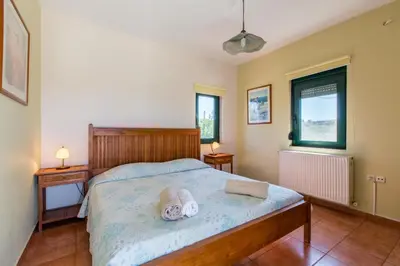 a bedroom with a bed with towels on it at Ellie Villa in Tersanas