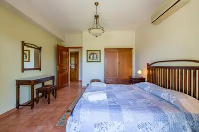 a bedroom with a large bed and a desk at Ellie Villa in Tersanas