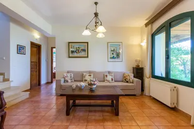 a living room with a couch and a table at Ellie Villa in Tersanas