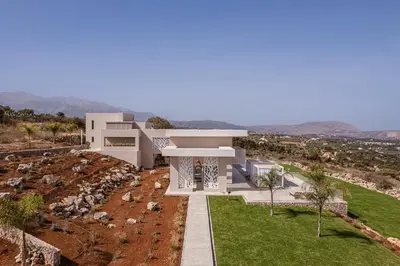 a large white house on top of a hill at Amazing Sea View Villa in Gavalochori