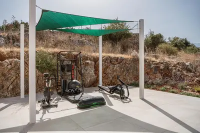 a gazebo with two bikes parked under it at Amazing Sea View Villa in Gavalochori