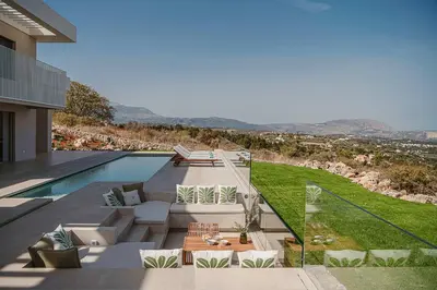 a backyard of a house with a swimming pool at Amazing Sea View Villa in Gavalochori