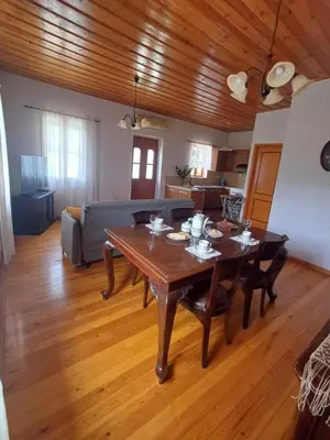 a living room with a table and a couch at Olive Stone in Kamisianá