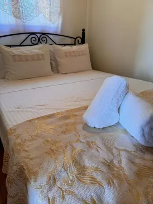 a bed with a white blanket and pillows on it at Olive Stone in Kamisianá