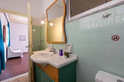 a bathroom with a sink and a mirror at The Orestis Old Cottage House in Stalos