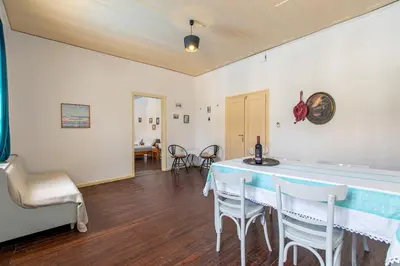 a dining room with a table and chairs at The Orestis Old Cottage House in Stalos