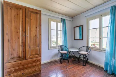 a dining room with a table and two chairs at The Orestis Old Cottage House in Stalos