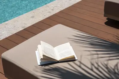 a book sitting on a table next to a pool at Memoire Guest House I Private Heated Pool I 200m beach in Chania Town