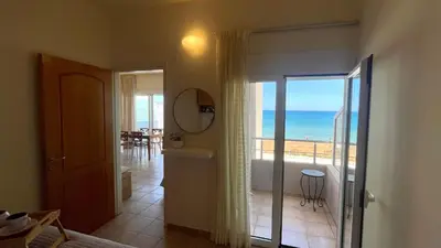 a bathroom with a view of the ocean from a room at Azzurro in Stalos