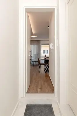 a hallway leading into a dining room with a table at Artemis Apartments in Chania Town