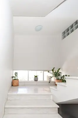 a white staircase in a house with potted plants at Artemis Apartments in Chania Town