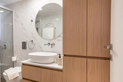 a bathroom with a sink and a mirror at Artemis Apartments in Chania Town