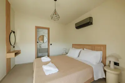 a bedroom with a bed with two towels on it at Madre Tierra Boutique Villa 2 in Liyidhés