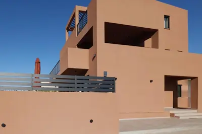 a building with a balcony on the side of it at Madre Tierra Boutique Villa 2 in Liyidhés