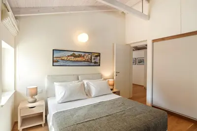 a bedroom with a large bed with white pillows at Kormoranos-Hydrobates Waterfront Villa in Chania Town
