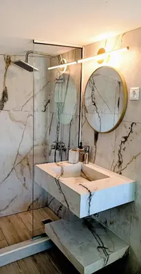 a bathroom with a sink and a mirror at Umoya in Palaiochóra