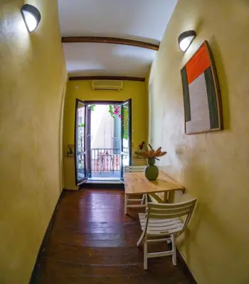 a hallway with a table and chairs in a house at Mythos -Old Town-Old harbour Chania in Chania Town