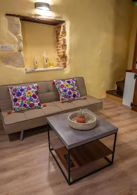 a living room with a couch and a table at Mythos -Old Town-Old harbour Chania in Chania Town