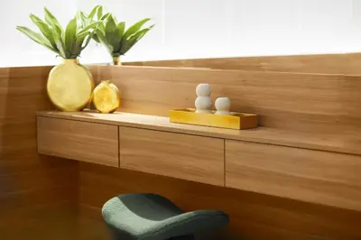 a wooden shelf with a chair and vases on it at Stavros Beachfront Suites in Agia Marina Nea Kydonias