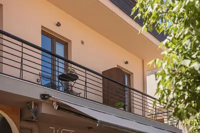 a balcony of a house with a table on it at KT Suites in Chania Town