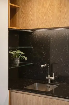 a kitchen with a sink and a black counter top at KT Suites in Chania Town