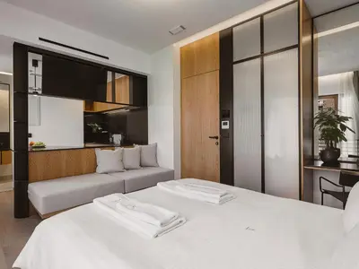 a bedroom with two beds and a couch at KT Suites in Chania Town