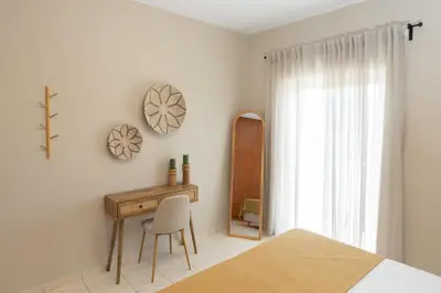 a bedroom with a desk and a bed and a window at kolymvari4you in Kolymvari
