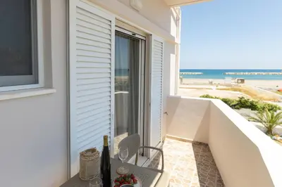 a balcony with a view of the beach at kolymvari4you in Kolymvari