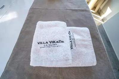 a white towel sitting on top of a table at Villa ViKaDa in Stalos