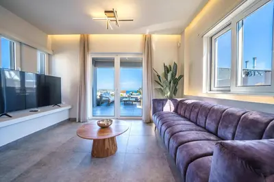 a living room with a couch and a television at Villa ViKaDa in Stalos