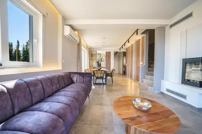 a living room with a couch and a table at Villa ViKaDa in Stalos