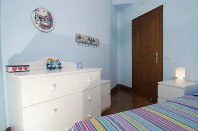 a bedroom with a white dresser and a bed at Villa Ektor in Kissamos