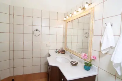 a bathroom with a sink and a mirror at Villa Ektor in Kissamos
