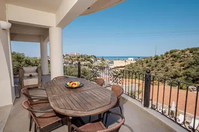 a table and chairs on a balcony with a view at Zen Maisonette Retreat in Daratso