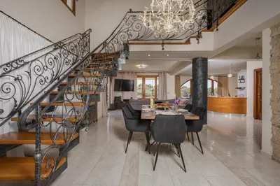 a dining room and living room with a spiral staircase at Zen Maisonette Retreat in Daratso