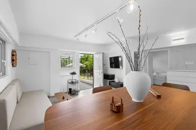 a vase on a wooden table in a living room at 6622 Luxury Apartment with Shared Pool in Chania Town
