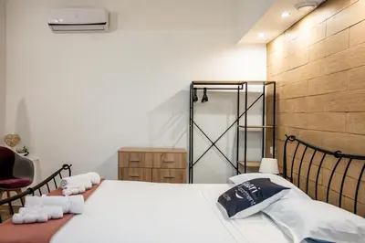 a bedroom with a bed with towels on it at Kamari Apartment - Chania in Chania Town