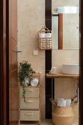 a bathroom with a sink and a mirror at Pithos Apartment in Korakiaí