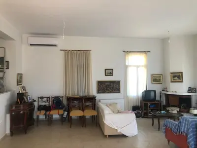 a living room with a couch and a table at Solar Retreat Maleme in Maleme