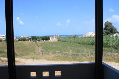 a view of a field from a window at Solar Retreat Maleme in Maleme