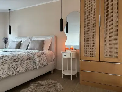 a bedroom with a bed and a dresser with a night stand at Batann Apartment in Palaiochóra