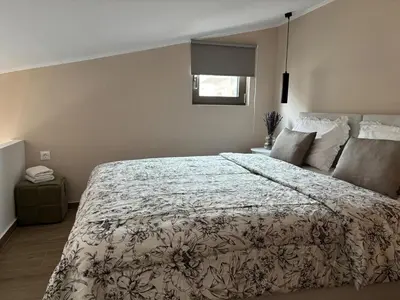 a bedroom with a large bed and a window at Batann Apartment in Palaiochóra