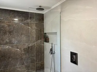a shower with a glass door in a bathroom at Batann Apartment in Palaiochóra