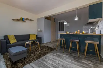 a living room with a couch and a kitchen at Jasmine Studio - at the heard of old town in Chania Town