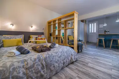 a bedroom with a large bed with pillows on it at Jasmine Studio - at the heard of old town in Chania Town