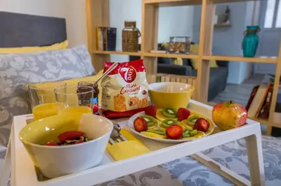 a table with a tray of food and fruit on it at Jasmine Studio - at the heard of old town in Chania Town